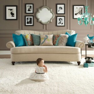 Cute baby sitting on carpet floor | Bob & Pete's Floors